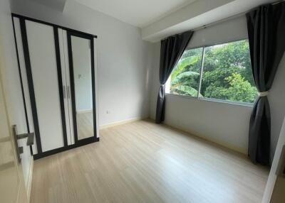 empty bedroom with large window and wardrobe