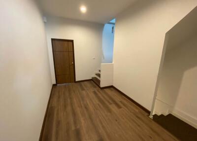 Hallway with wooden flooring and stairs