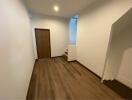 Hallway with wooden flooring and stairs