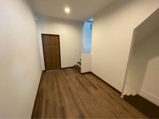 Hallway with wooden flooring and stairs