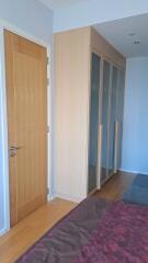 Bedroom with closet and wooden door