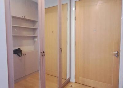 Spacious entryway with a large mirrored closet