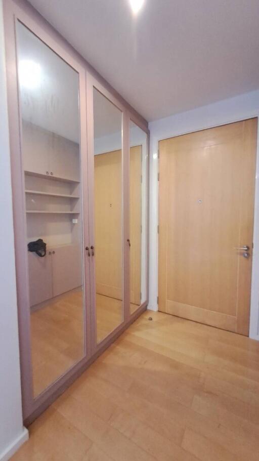 Spacious entryway with a large mirrored closet