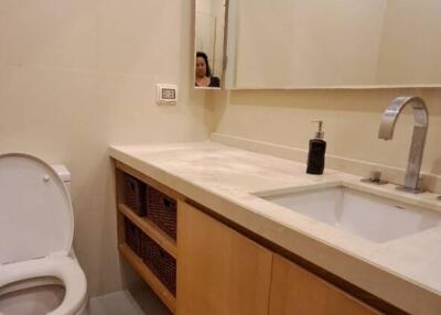 Modern bathroom with sink, mirror, and toilet