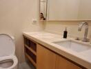 Modern bathroom with sink, mirror, and toilet