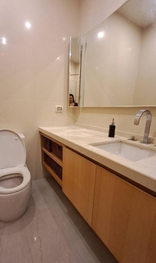 Modern bathroom with sink, mirror, and toilet