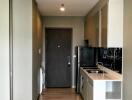 Modern kitchen with wooden flooring and entry door