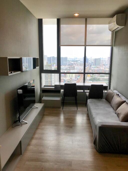 Modern living room with a window view in a high-rise building