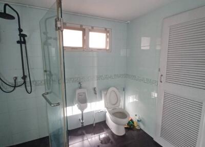 Bathroom with clear glass shower and toilet