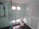 Bathroom with clear glass shower and toilet