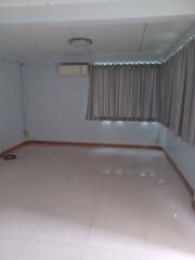 Empty room with tiled floor, air conditioner, and curtains