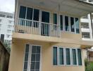 Two-story house with balcony and several windows