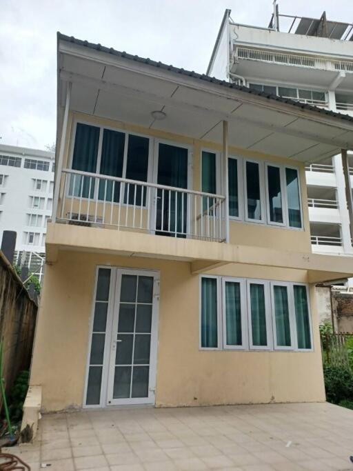 Two-story house with balcony and several windows