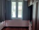 Bedroom with wooden flooring and window