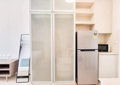 Modern kitchen with fridge and cabinets