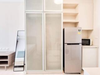 Modern kitchen with fridge and cabinets