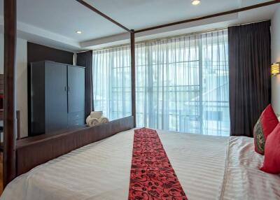 Bedroom with large window and four-poster bed