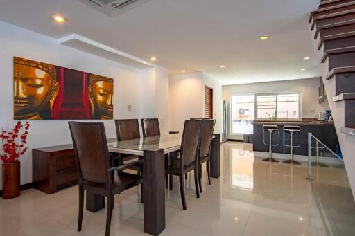 modern dining area with adjacent kitchen