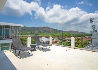 Terrace with lounge chairs and view of mountains