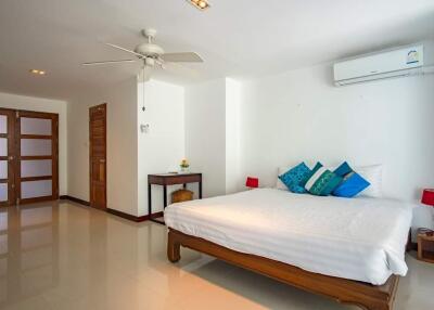 Spacious bedroom with wooden furniture and modern amenities
