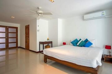 Spacious bedroom with wooden furniture and modern amenities