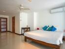 Spacious bedroom with wooden furniture and modern amenities