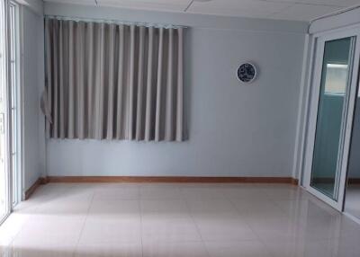 Empty room with tiled floor and curtains