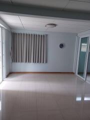 Empty room with tiled floor and curtains