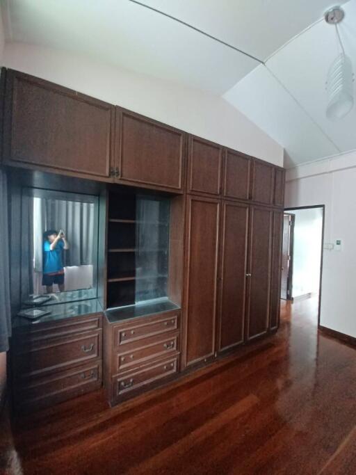 Built-in wooden wardrobe with mirror in bedroom