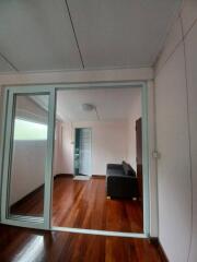 Living room with wooden floor and glass doors