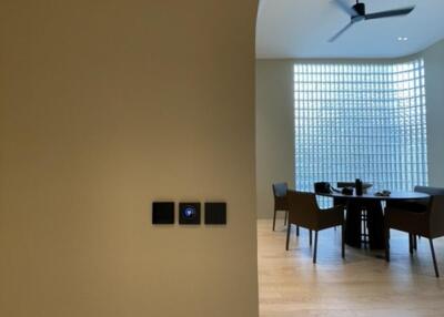 Dining area with modern furniture and large glass-block window