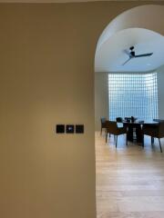 Dining area with modern furniture and large glass-block window