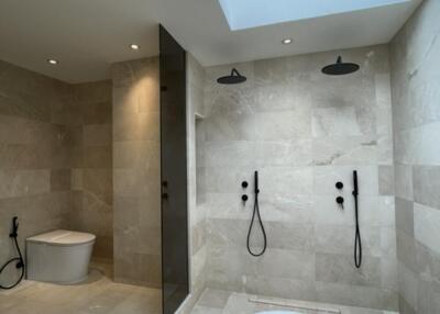 Modern bathroom with dual showers and a skylight