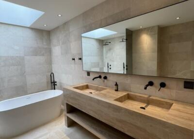 Modern bathroom with double sink vanity and freestanding tub