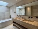 Modern bathroom with double sink vanity and freestanding tub