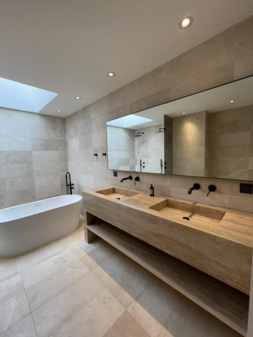 Modern bathroom with double sink vanity and freestanding tub