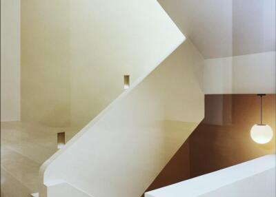 minimalist modern stairway with geometric design and pendant light