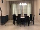 Modern dining room with black chairs and a round table