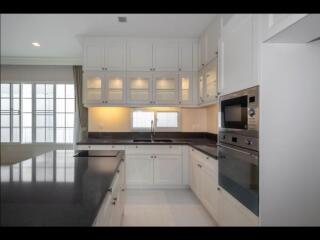 Modern kitchen with white cabinets and black countertops