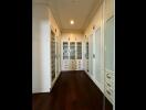 Spacious walk-in closet with ample storage and hardwood floor