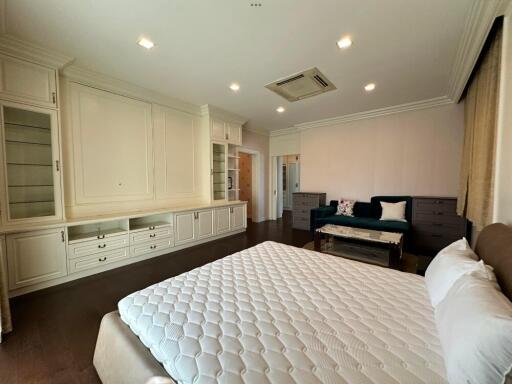 Spacious bedroom with built-in storage and modern lighting