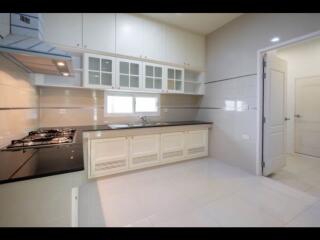 Modern kitchen with black countertops and white cabinetry