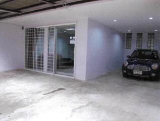 garage with car and sliding door