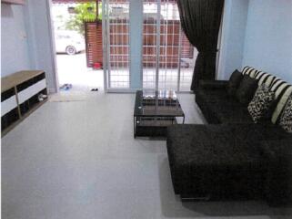 Living room with a black sofa and glass coffee table