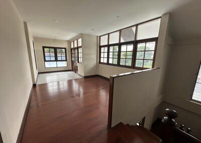 Spacious main living area with wooden flooring and large windows