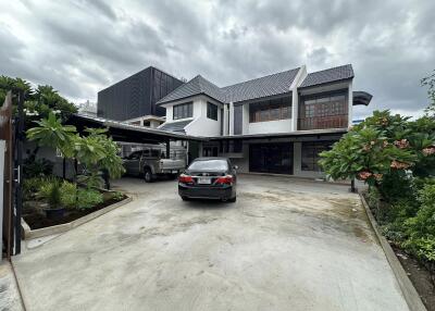 Exterior view of a modern house with driveway and cars