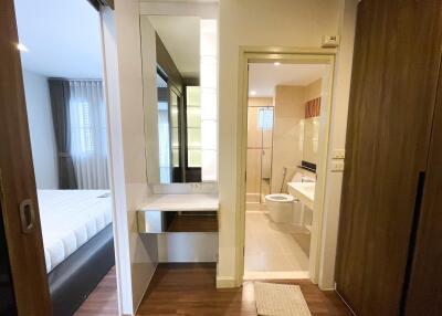 View of a bathroom with a vanity area, and a glimpse into a bedroom