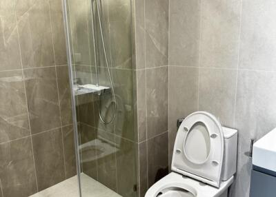 Modern bathroom with glass shower enclosure and toilet