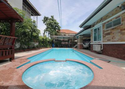 Outdoor pool view with hot tub