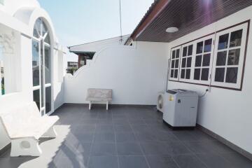 Outdoor balcony with seating and air conditioning unit